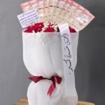Red Velvet Radiance – Premium Rose Bouquet with Saudi Riyal Fan & White Mesh Wrap